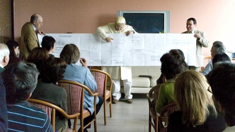 8.jpg - Raja Mariano and Dr Ubaldo present to the assembly plans for the land they will acquire near Rome which include buildings and a Tower of Invincibility for Italy.