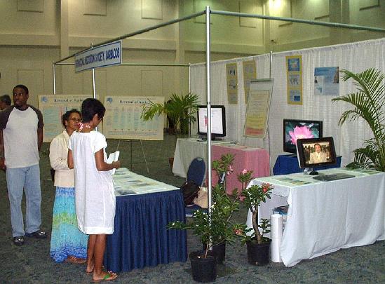 13.jpg - 10 September 2009Leaders of the Global Country of World Peace were impressed with the sophisticated set up of the convention displays. Winston Walker, and Dr Kayshwarie Simmons answer questions from an interested conventioneer.