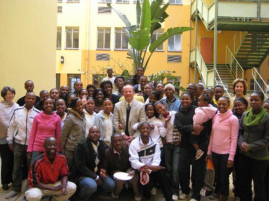 8.jpg - Maharishi Institute students pose with teacher Jim Turner and Maharishi University of Management MBA student Jesse Berkowitz. Part tertiary and vocational education, part technology training, part entrepreneurship in action, ?Invincible Outsourcing? is the first of its kind, combining three business models into one.