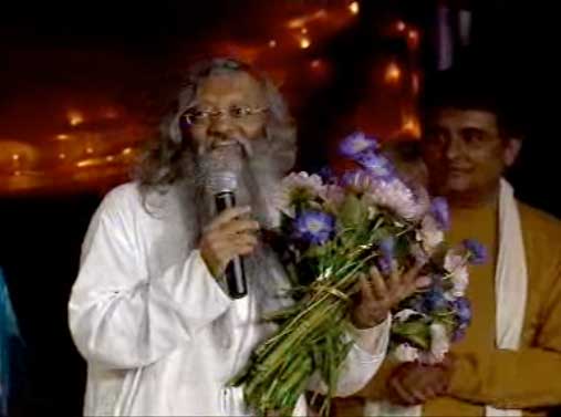 Picture-57.jpg - Concert Master, Brahmachari Girish Momaya, presents flowers to Ashish Sankrityayan, Classical Vocal Droopad singer at Maharishi  Gandharva Veda Festival for World Peace.