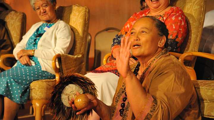 USA_GGN_6.jpg - 10 November 2010Honored Traditional Hawaiian guest from Kauai shares some of the hand motions, which signifying different aspects of nature, used in the traditional Hawaiian dance, the hula.  Guests from the Wahtaha and Mauri Natons in New Zealand watch on.