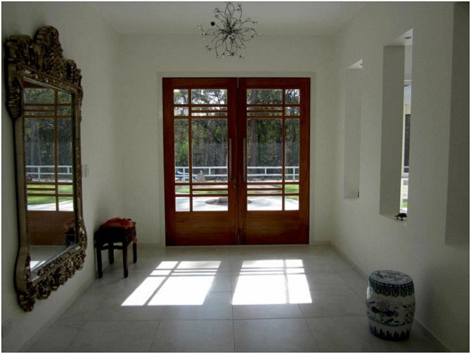 avastu9.jpg - Both owners have a strong background in art and design, and their influence is seen everywhere from the overall design to many interior details, including these front doors.