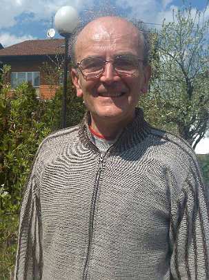 37-15042010308.jpg - Angelico, National Director of the Global Country of World Peace for Bosnia, stands before a four story house that has been purchased to be used for all Transcendental Meditation activities.