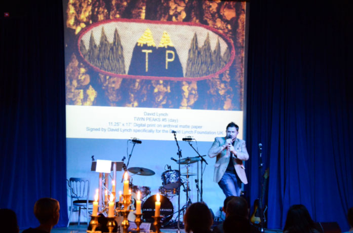 26-DLF.jpg - Mr Breese, in perfect auctioneer style, turned the hall into a lively scene and generated lots of bidding from the audience. On the screen, up for auction, is a ?Twin Peaks? (TP) print by David Lynch.