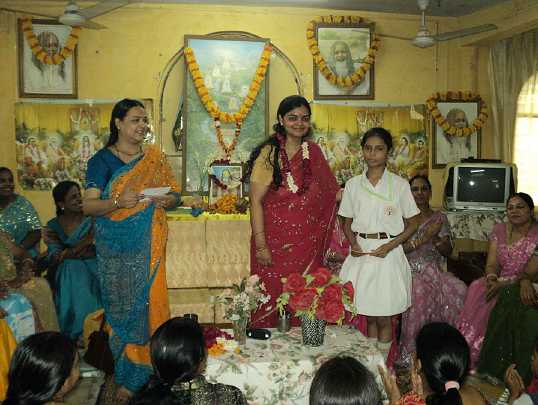 11.jpg - Maharishi Nagar, Uttar Pradesh: Miss Aditi Shrivastava, in red,  was the guest of honour at the Guru Purnima celebration. She addressed the celebration and awarded prizes to the children.