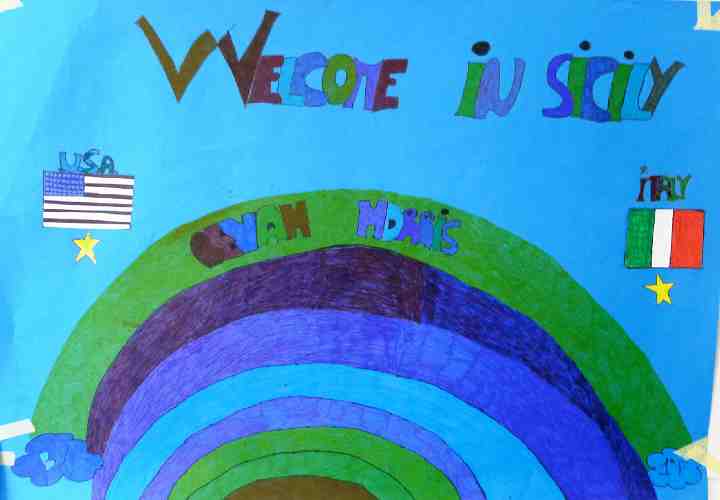 Italy-156.jpg - Students welcome Dr Bevan Morris of the USA to Sicily with a big, colourful poster, showing the flags of the two countries.